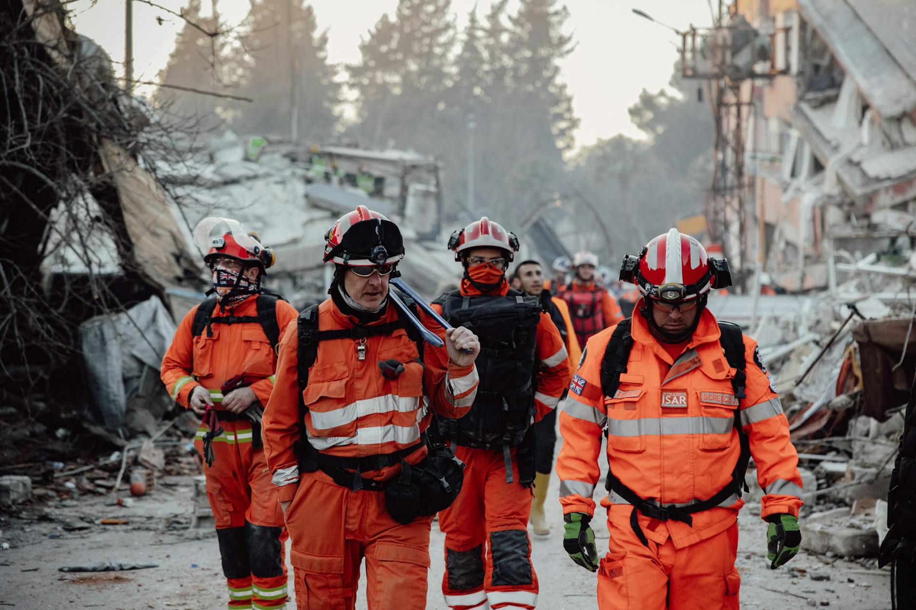 group of paramedics walking through a demolished city