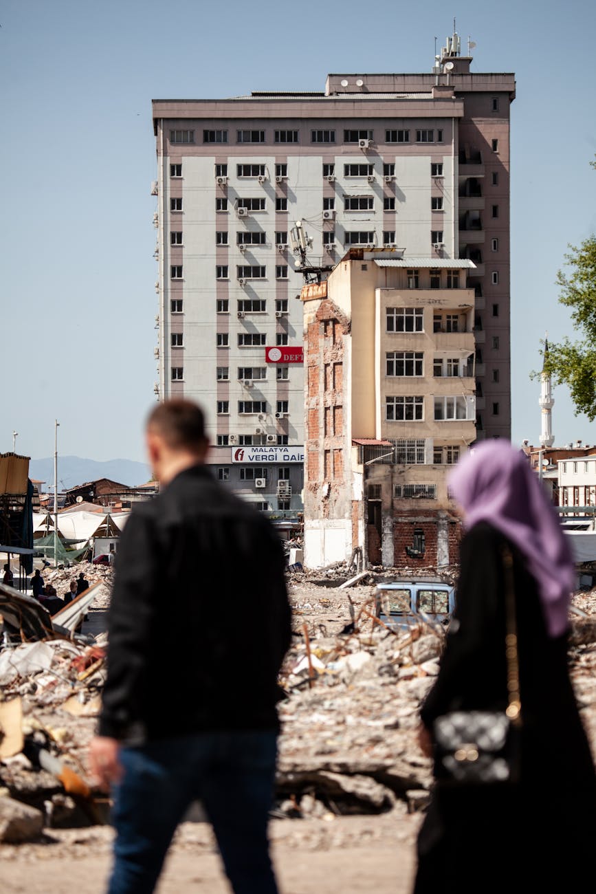 woman and man walking in town after earthquake