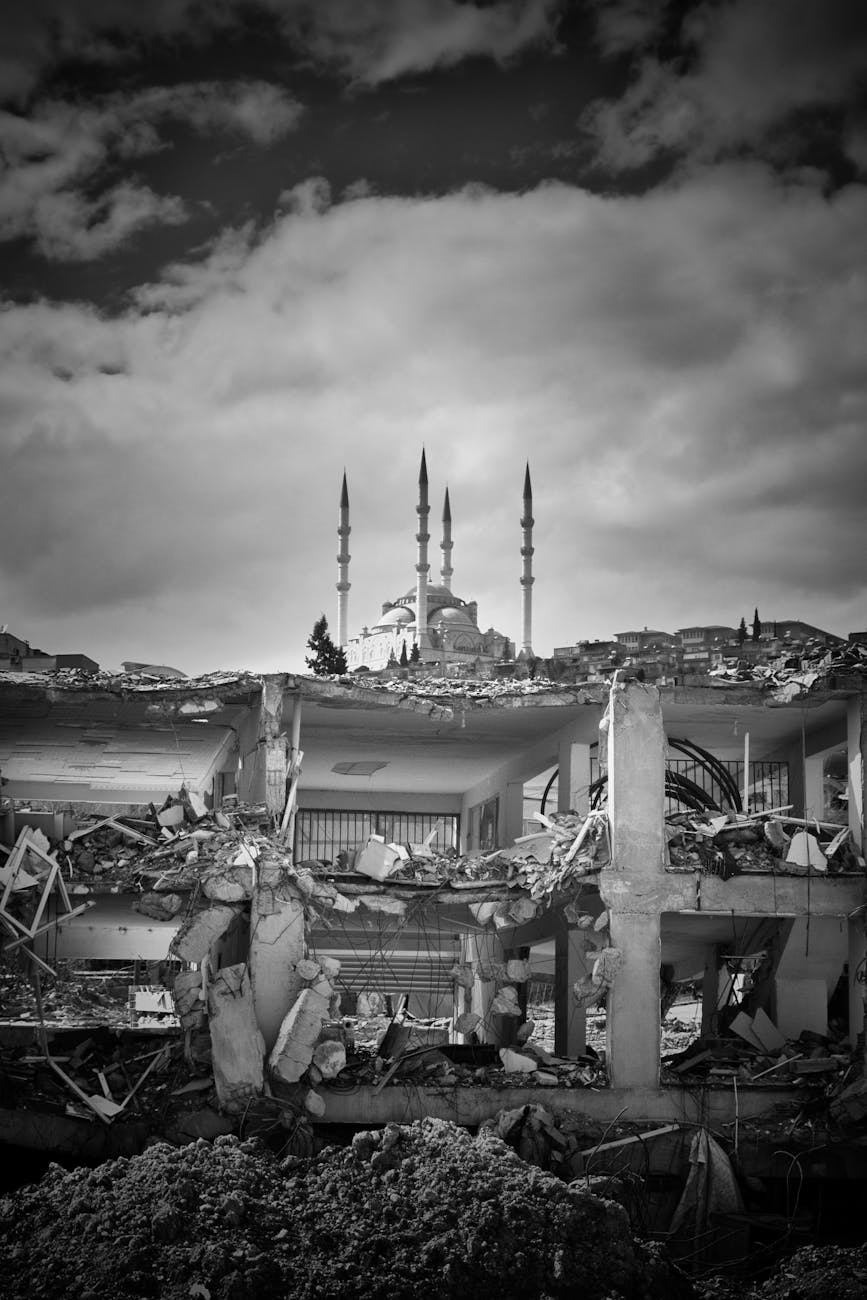 mosque seen behind ruins of a collapsed house