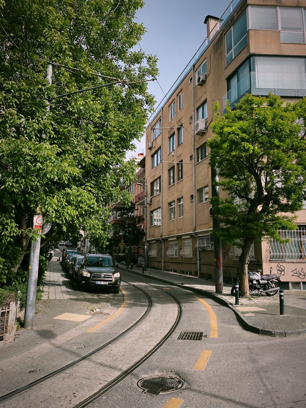 charming istanbul street with tram tracks and verdant trees