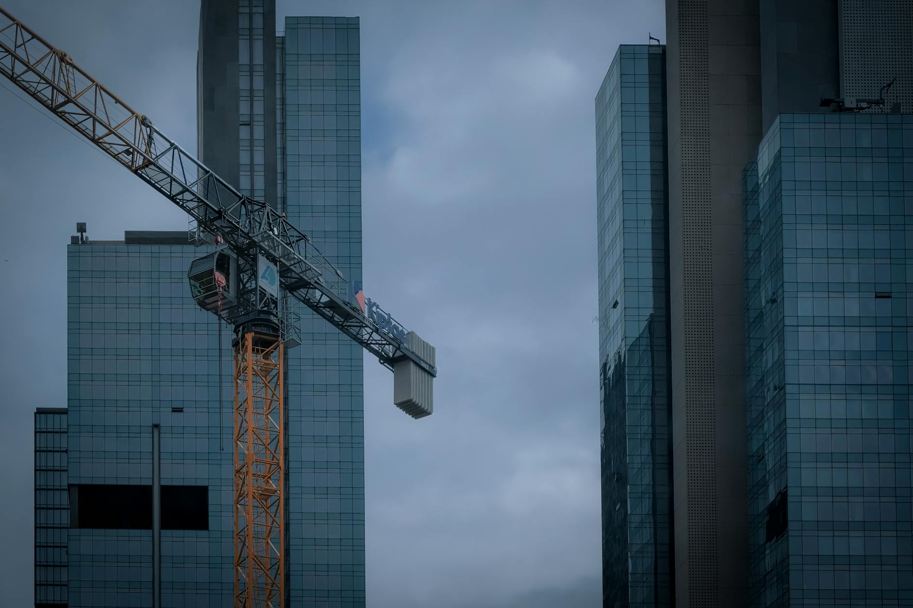 industrial crane against office skyscrapers