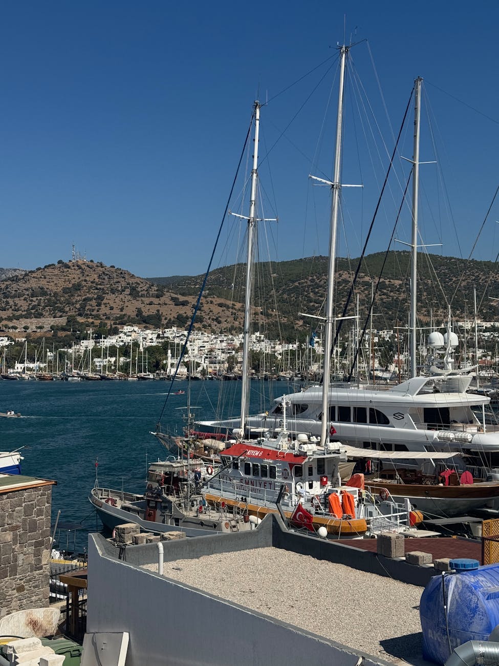 sailboats and yachts moored in coastal harbor