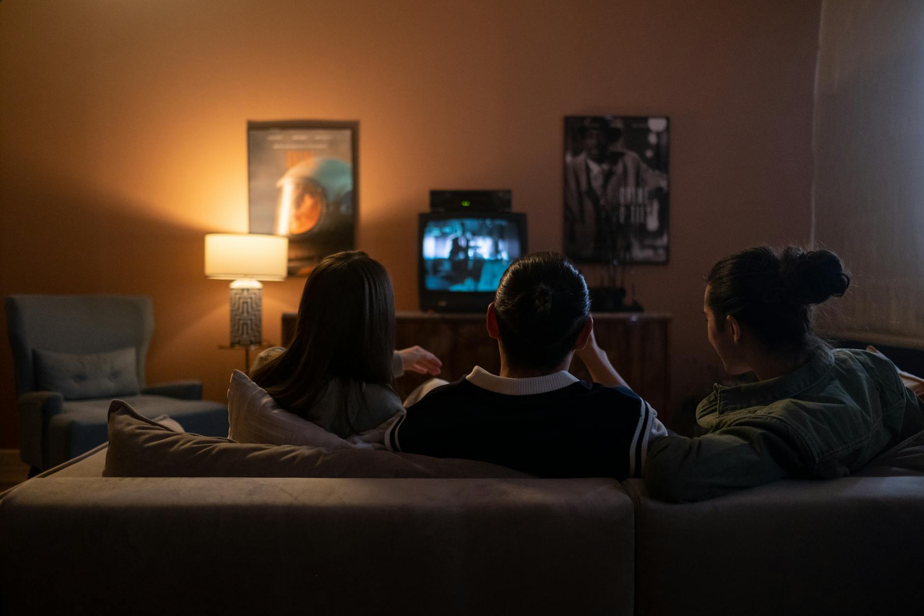 friends sitting on the couch and watching film