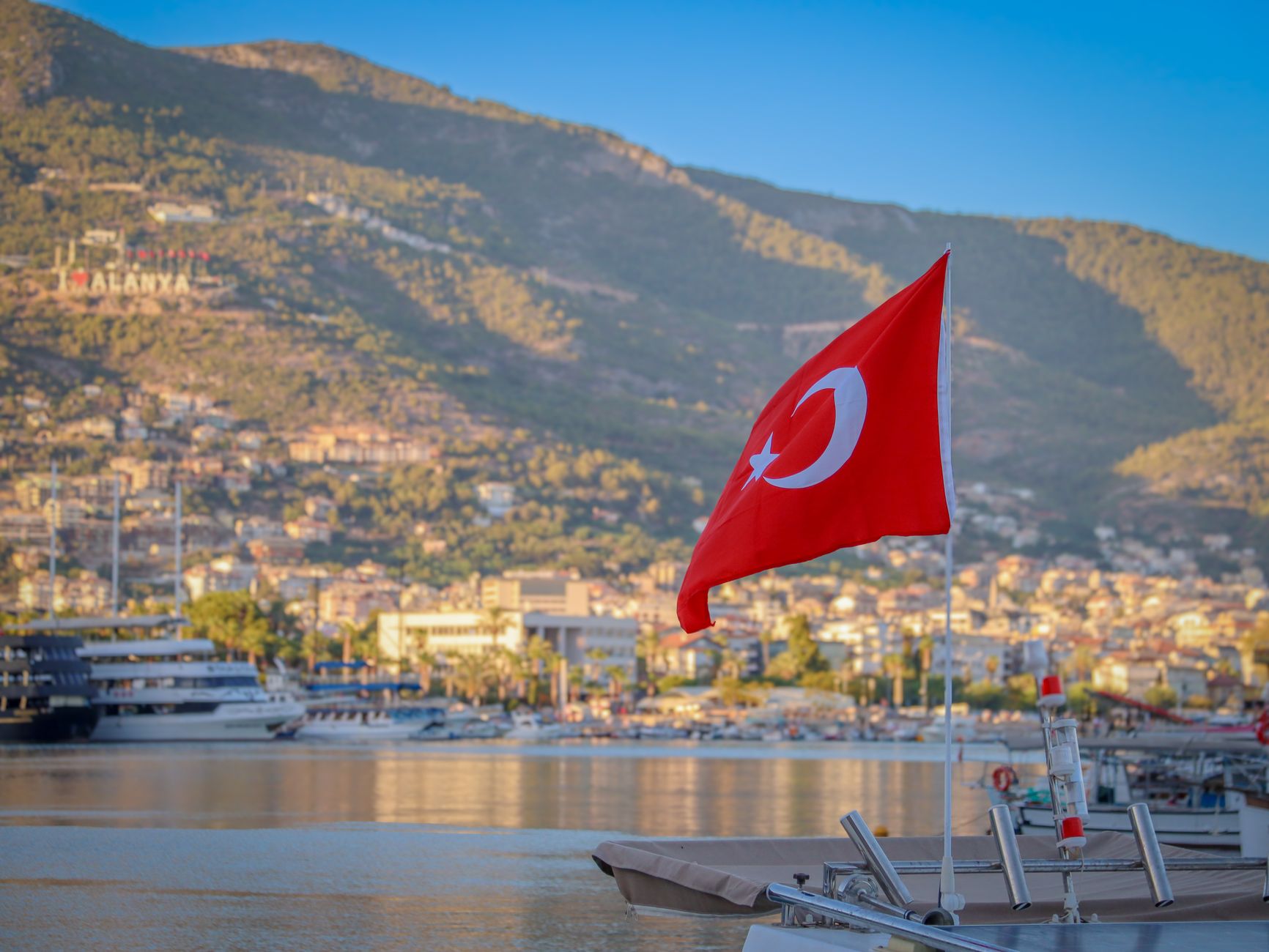 Portul Alanya scenic view of turkish flag on boat in alanya harbor