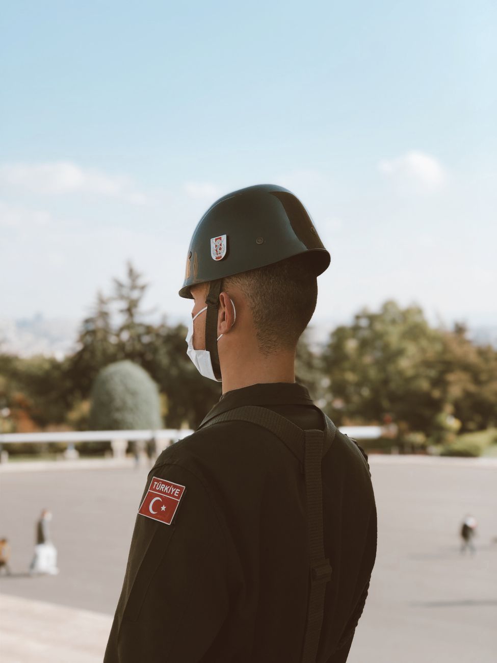 a soldier standing with a helmet on his head